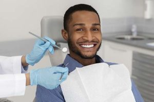 man learning about cosmetic dentistry services 