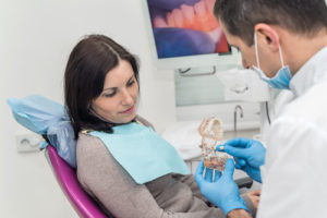 woman learning about dental crowns and bridges