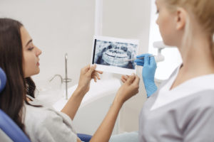 woman looking at her impacted teeth