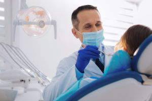 dentist performing root canal treatment