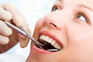 patient being checked for dental fillings and dental sealants 