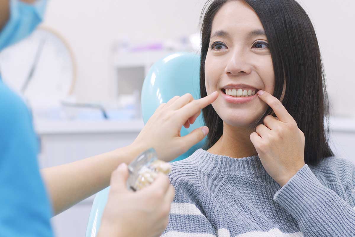 woman learning about a dental implant