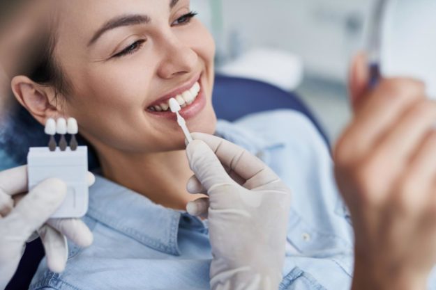 a woman sees the benefits of dental veneers